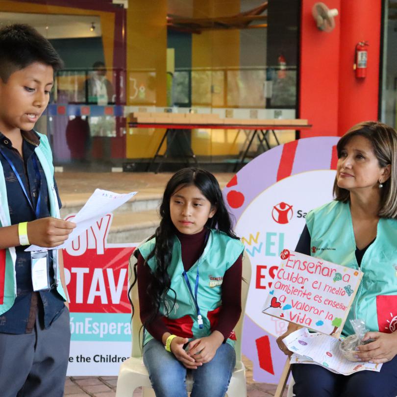 A boy standing up talking to a national authority from Guatemala as part of Generation Hope campaign
