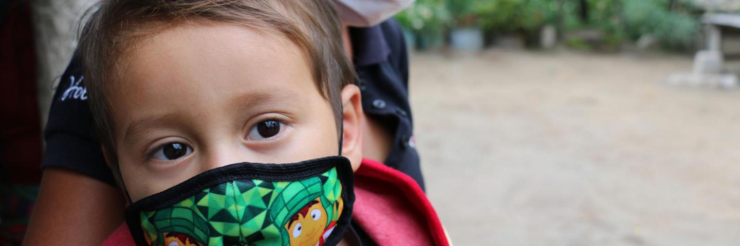 Little boy with his mom, wearing a mask