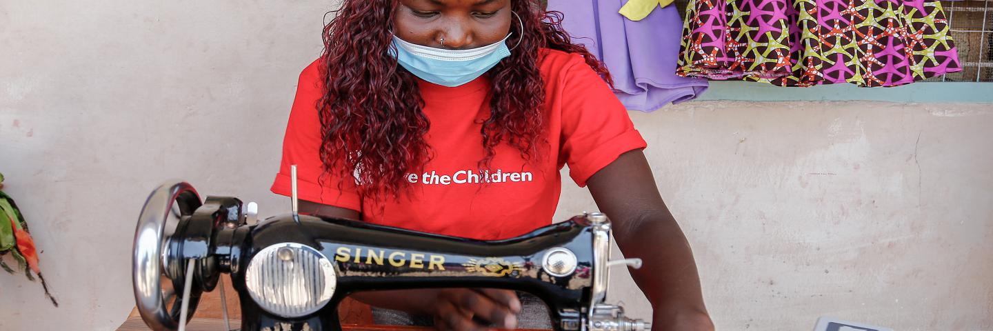 Rita examining her sewing machine in Turkana, Kenya