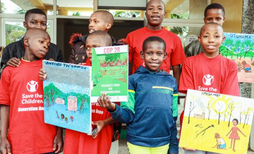 Child representatives at Rwanda's National Children Simulation showing their paintings of climate change