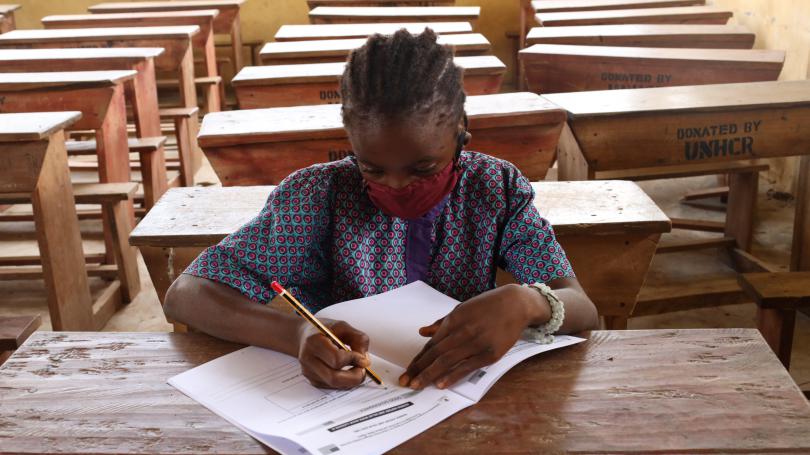 An adolescent girl studying in a classroom 