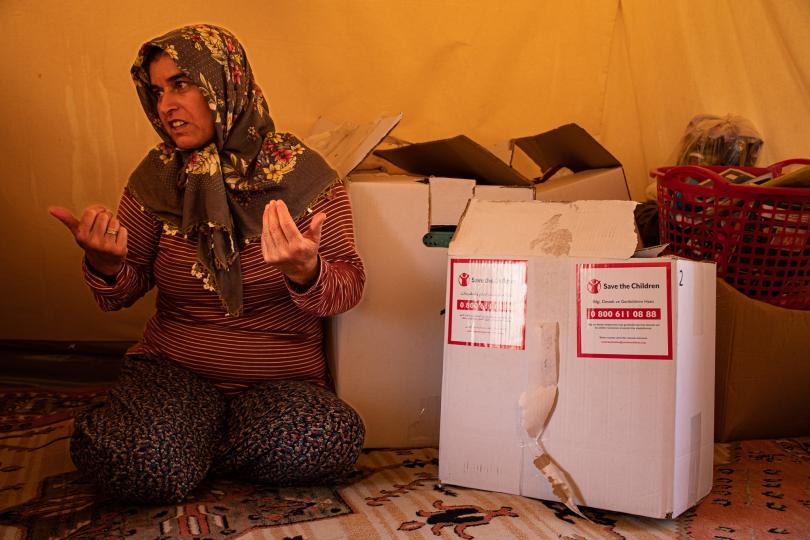 Derya* inside her tent next to her house that was destroyed during the earthquake in a remote village of Adıyaman. She receivedhygiene items thanks to support from the European Union. Ayşe Nur Gençalp/Save the Children Türkiye. 