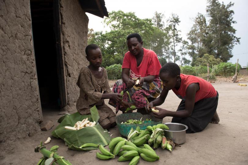 The family at home with the bananas they've grown. Hannah Maule-Ffinach / Save the Children