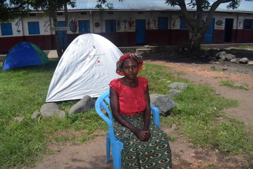 Joseline outside her tent at an IDP site at a local school. Stella Nassolo /Save the Children