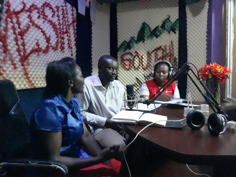 Annet and government officials talk about Ebola at the local radio station