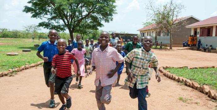 Children run to school in central Uganda. Andrew Pacutho / Save the Children