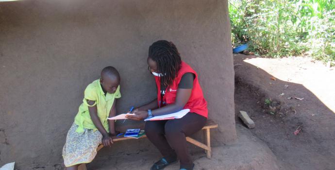 Save the Children staff distribute home learning packs in Kyangwali. Editor Asaba / Save the Children