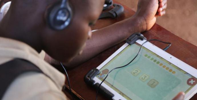 Schoolgirl using the tablets in West Nile. Alun McDonald / Save the Children