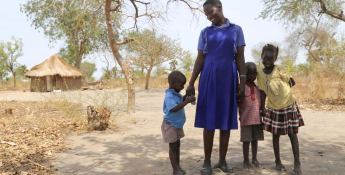 Juliet with her twin boys and another young relative she cares for in Palorinya settlement. Alun McDonald / Save the Children