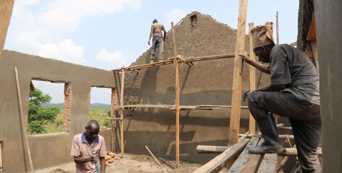 Constructing new classrooms at Muhega primary school. Alun McDonald / Save the Children